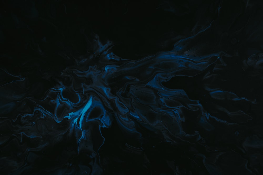 a black background with blue swirls in the middle