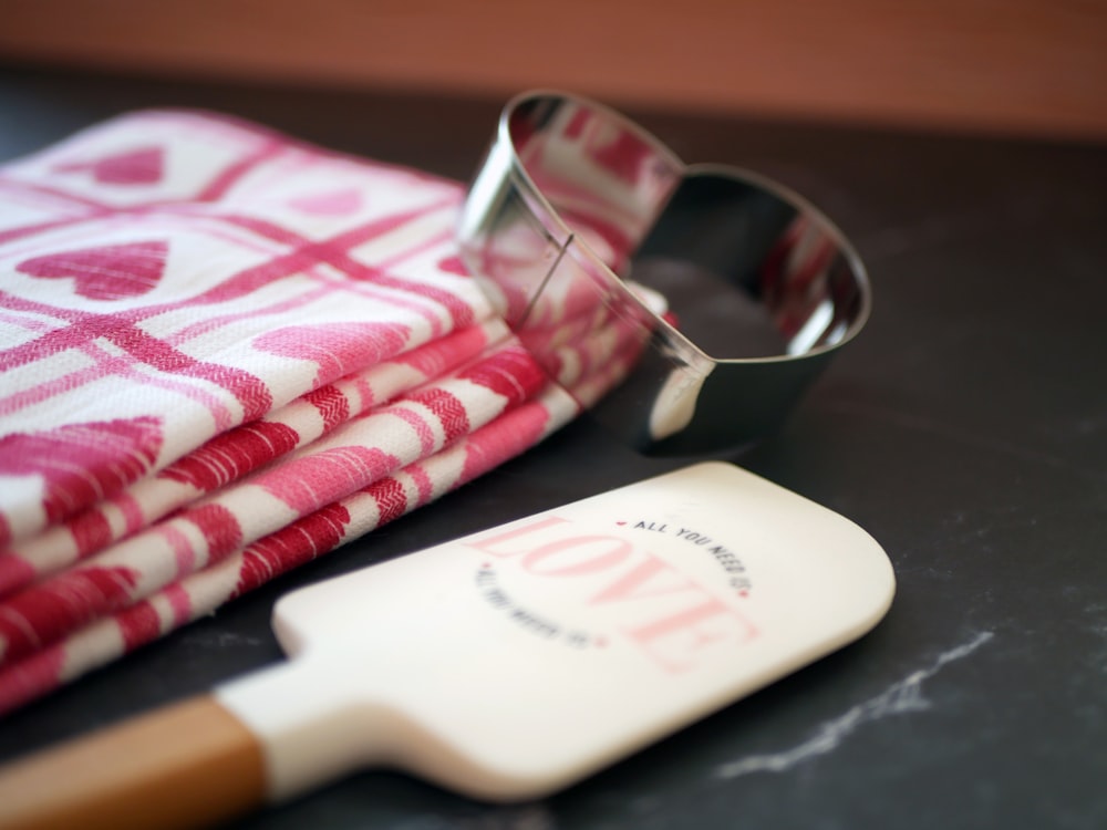 a pair of glasses sitting on top of a table next to a napkin