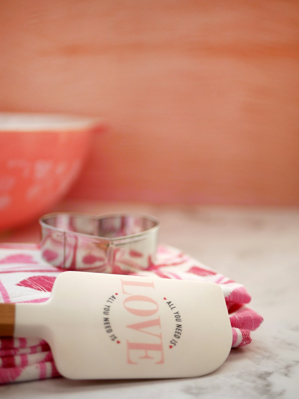 a bottle of love on a towel next to a bowl