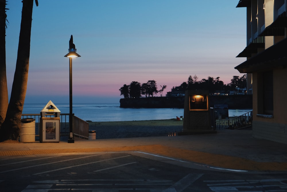 a street light sitting next to a beach