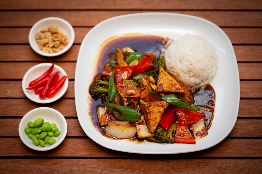 a white plate topped with meat and veggies