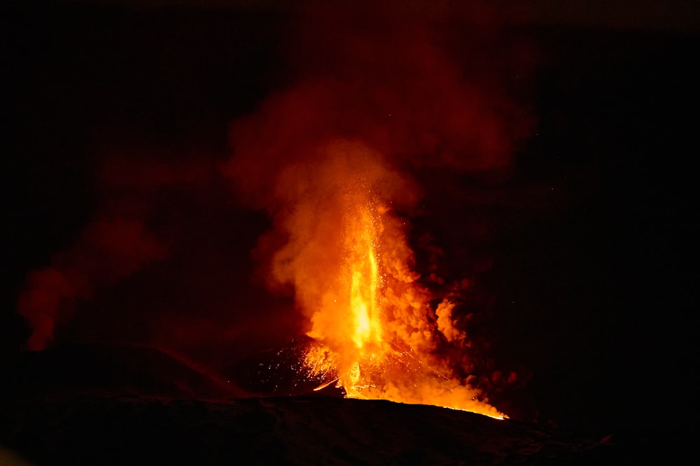 a large fire blazing in the dark sky