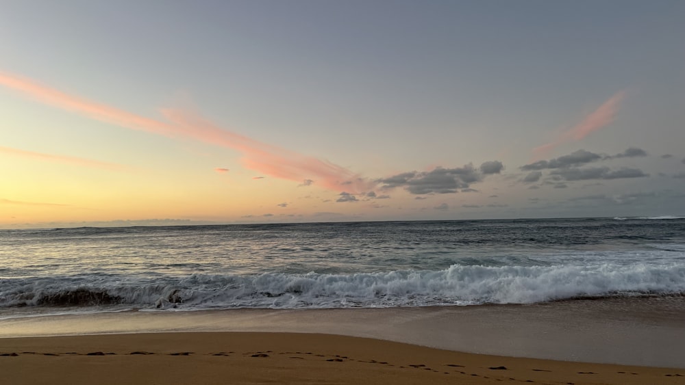 a beach with a wave coming in to shore