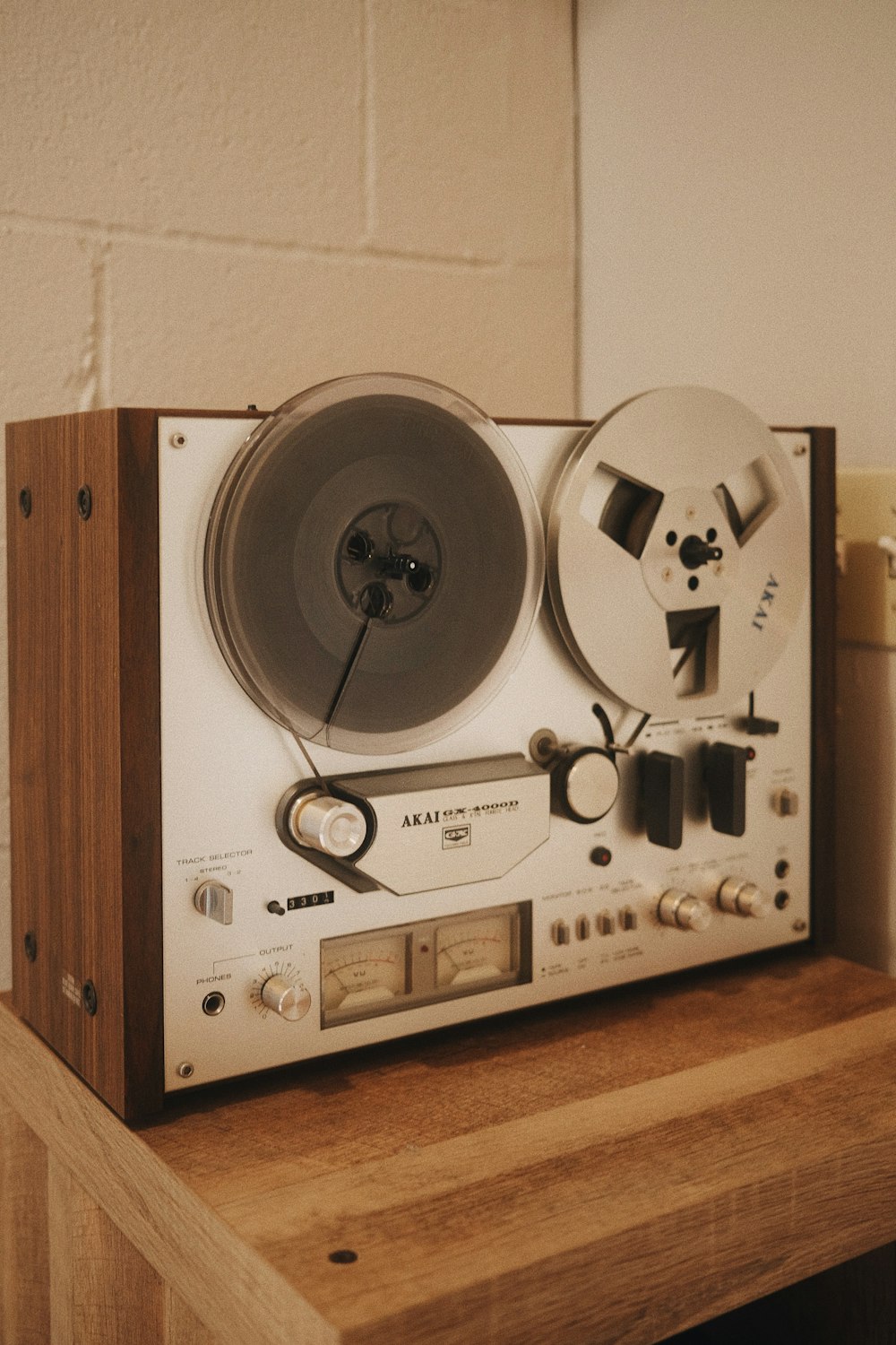 a record player sitting on top of a wooden table