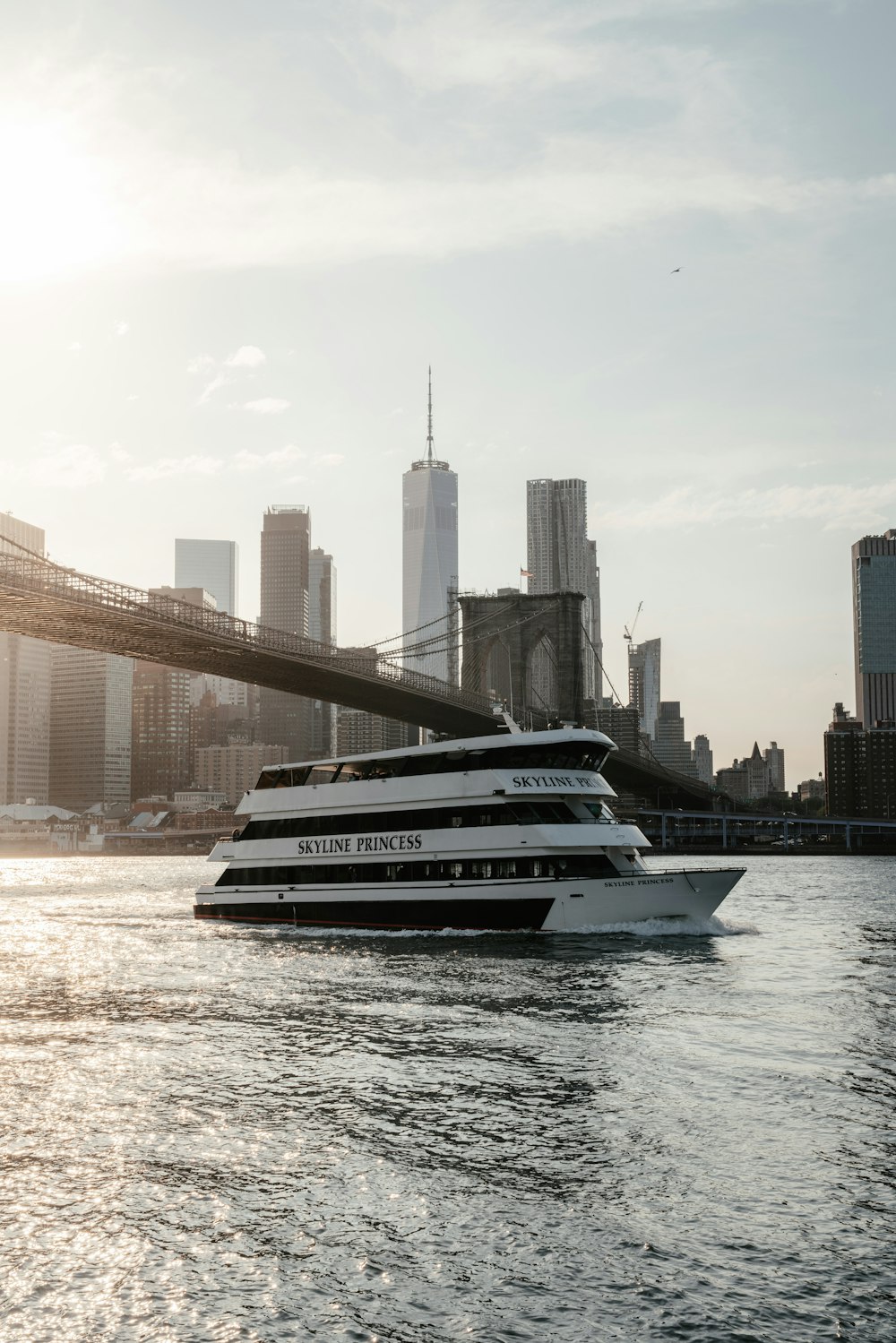 a large boat in the water near a bridge