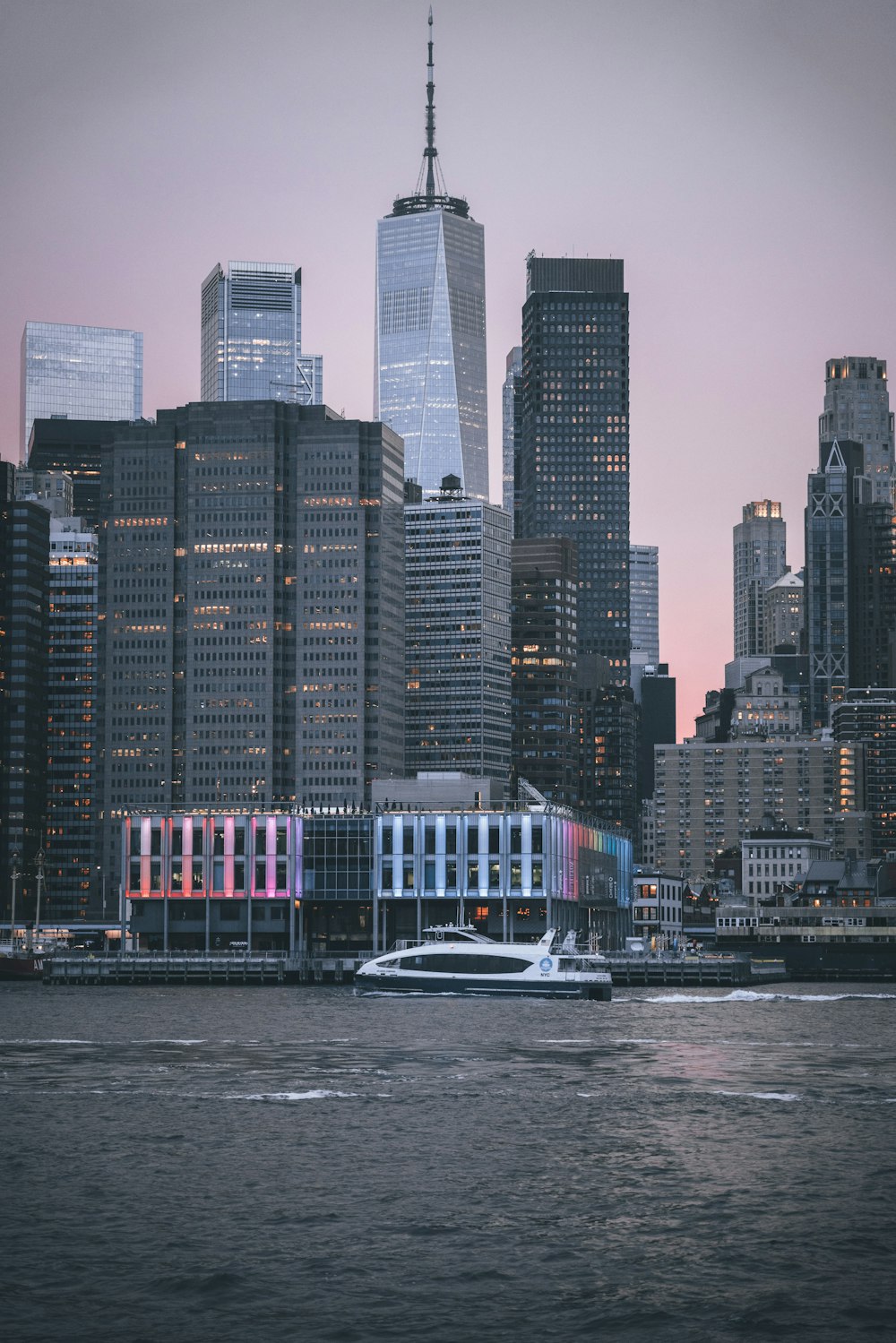 a boat in a body of water near a large city