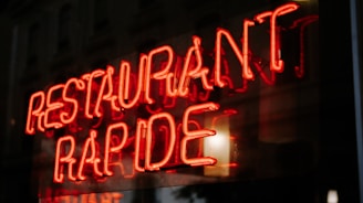 a neon sign that reads restaurant rapide
