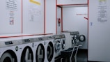 a row of washing machines in a laundry room