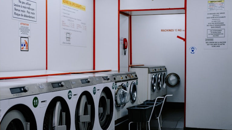 a row of washing machines in a laundry room