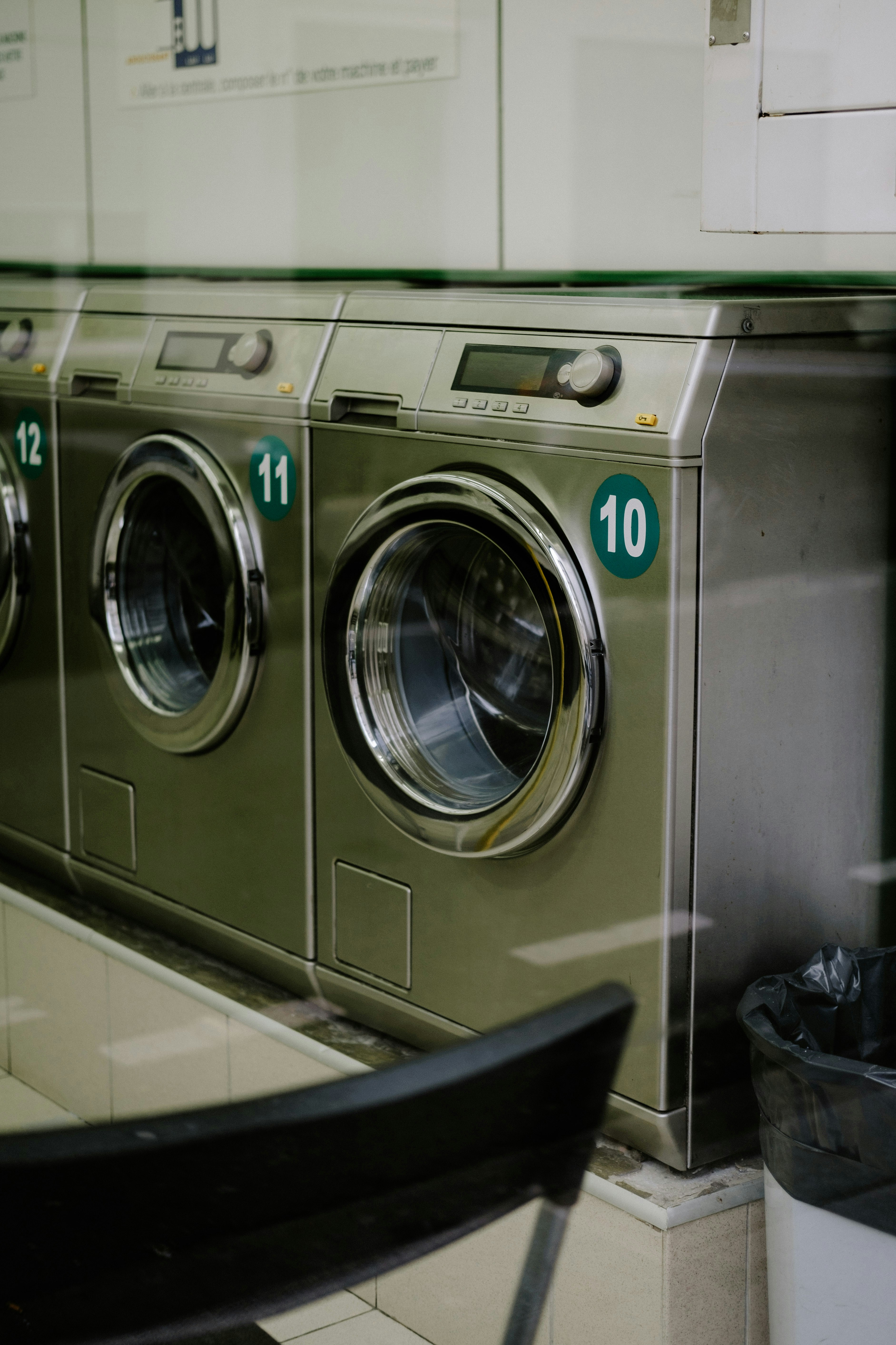 a row of washing machines in a laundry room