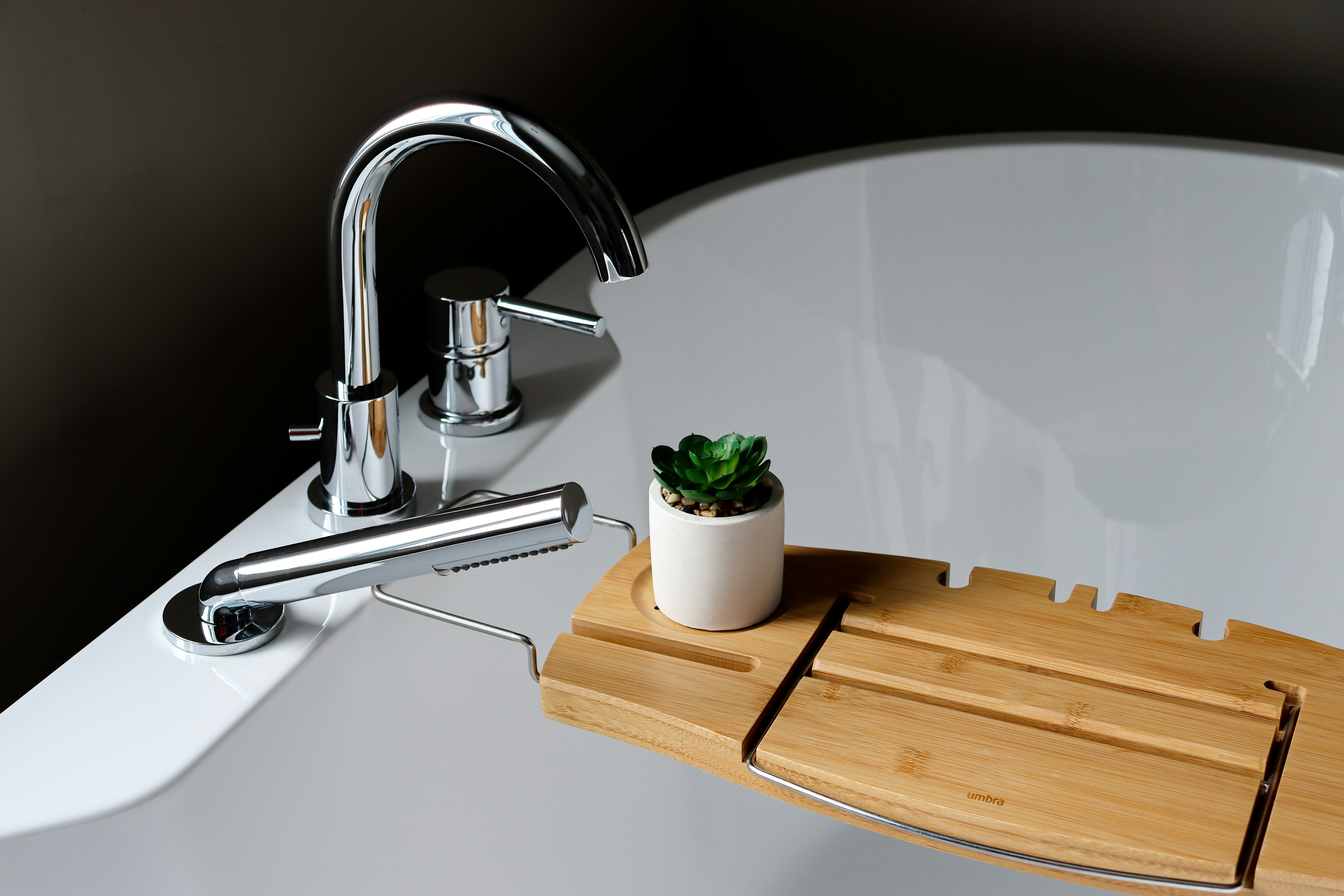 Bathtub with deck-mounted faucets