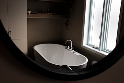 a white bath tub sitting next to a window