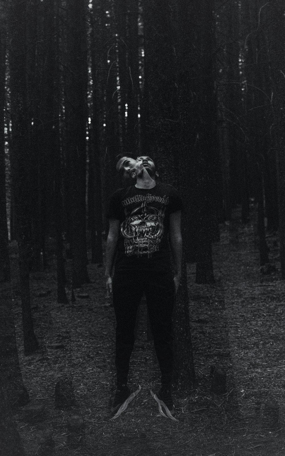 a man standing in the middle of a forest