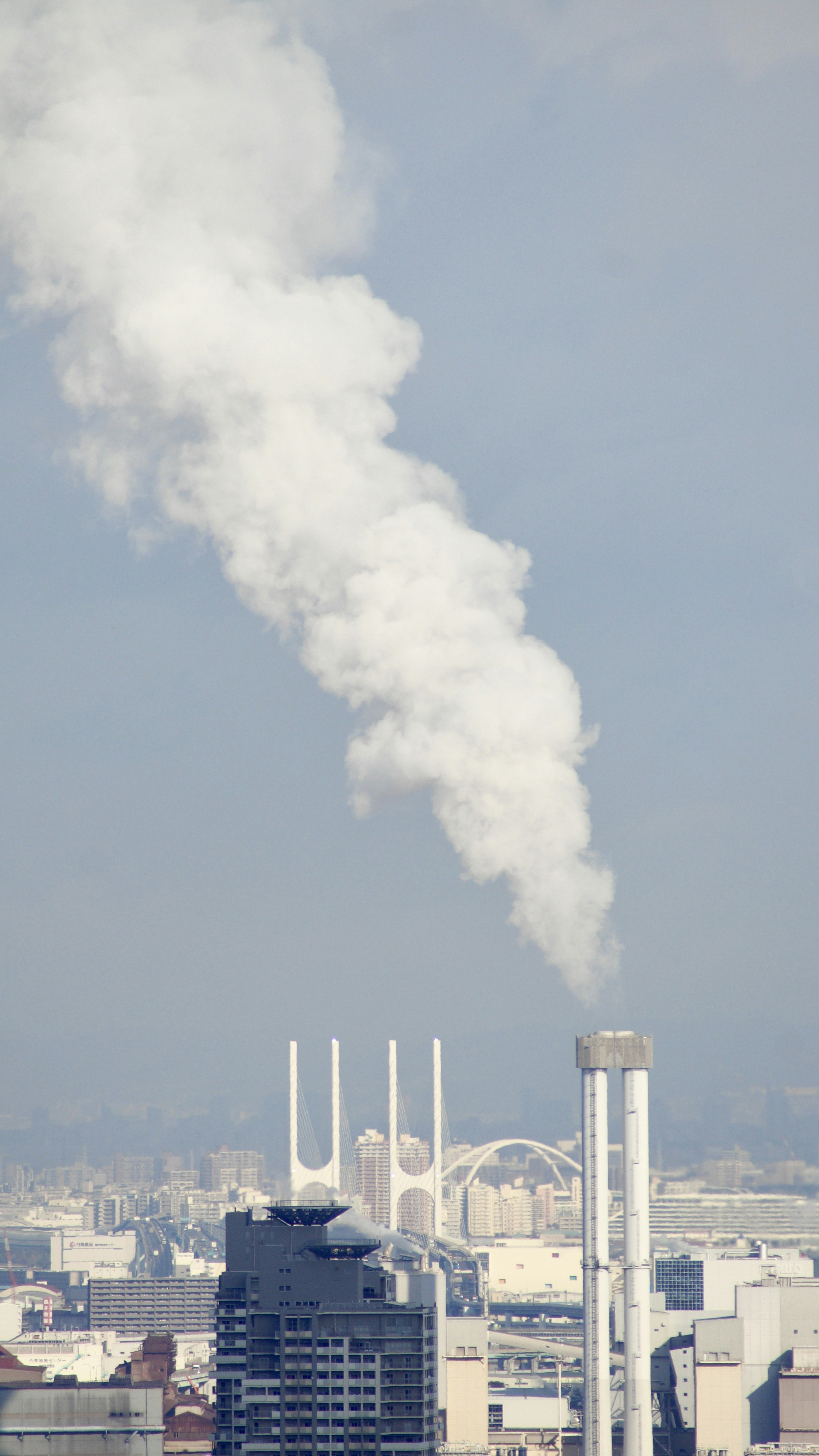 a smokestack emits from the top of a building