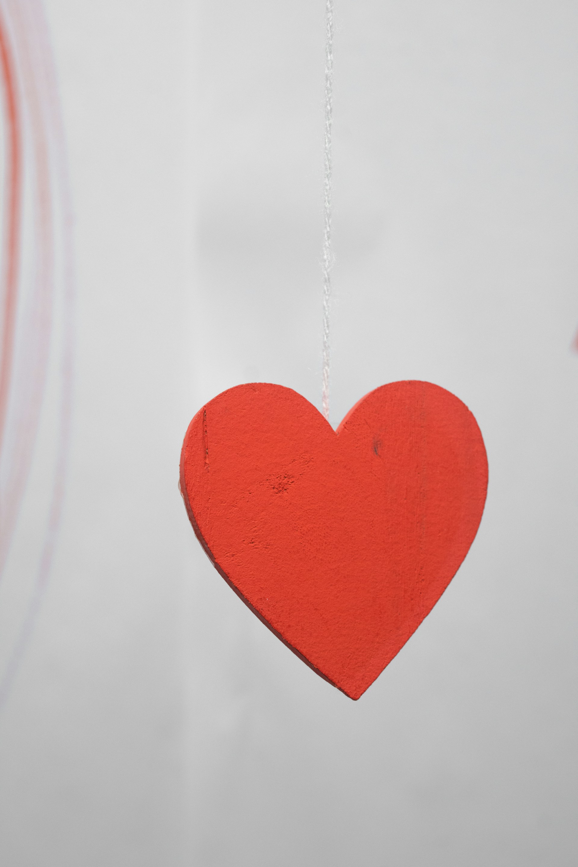 a red heart hanging from a string
