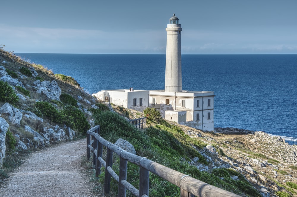 a lighthouse on a cliff overlooking the ocean