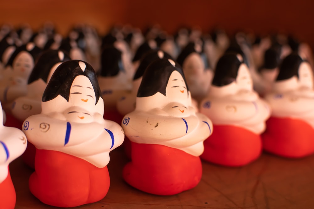 a row of small ceramic figurines sitting on top of a table