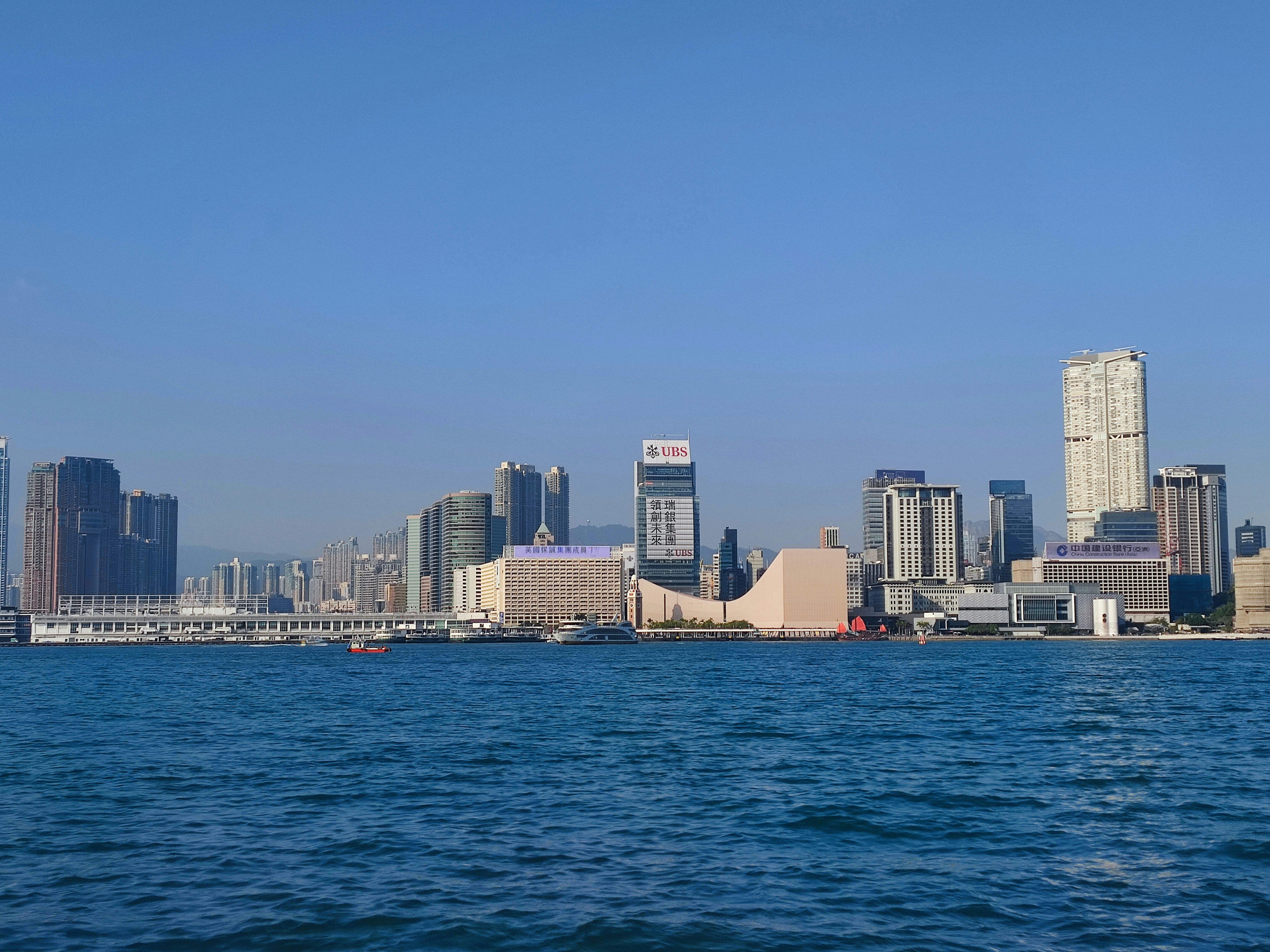 From left to right: Star Ferry Pier, Star House, Hong Kong Cultural Centre, Hong Kong Museum of Art. This is the tip of Kowloon Peninsula and coastline of the area called Tsim Sha Tsui. The skyscraper building on the right is a luxurious apartment building called The Masterpiece (Hong Kong).