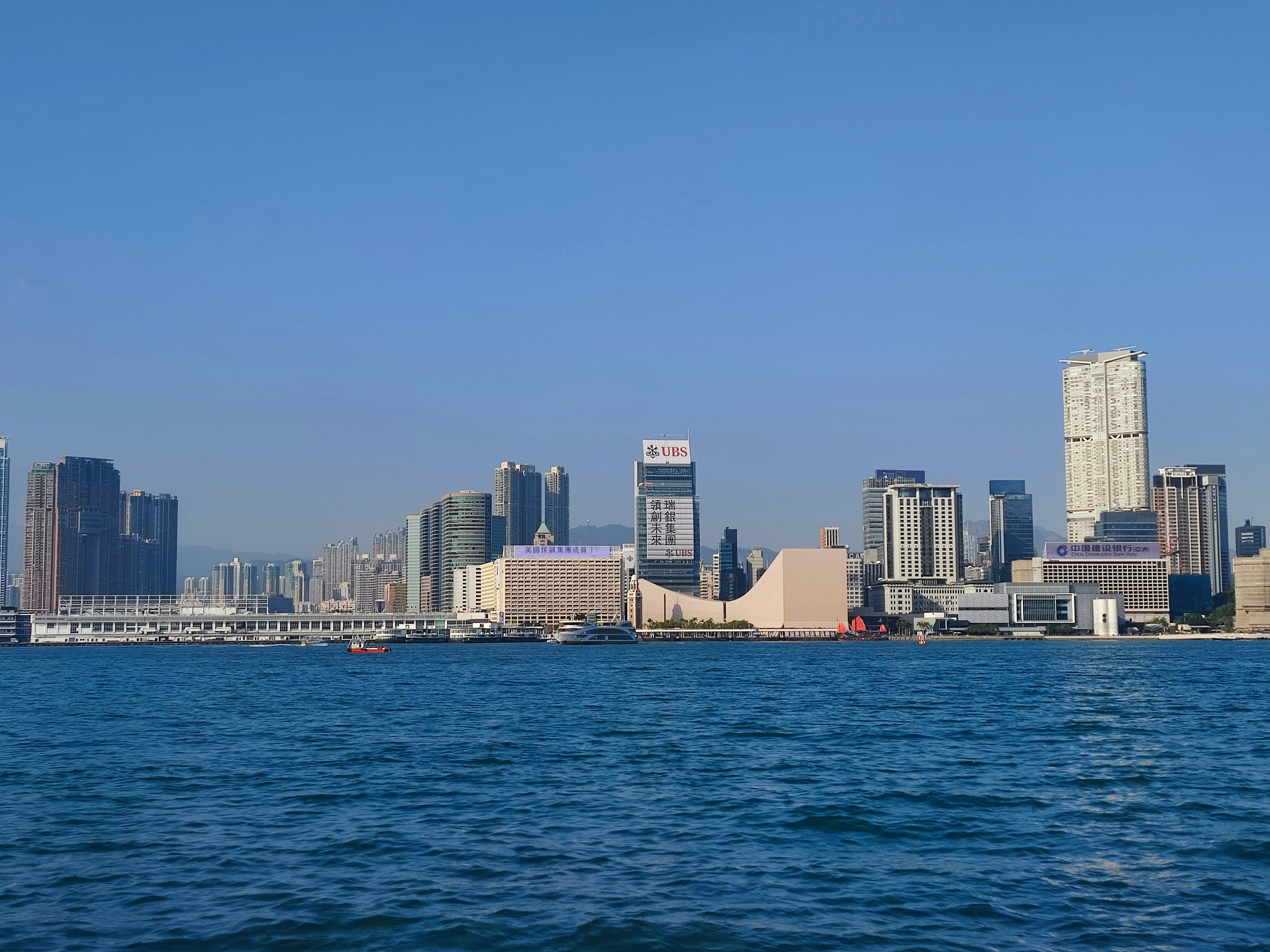 From left to right: Star Ferry Pier, Star House, Hong Kong Cultural Centre, Hong Kong Museum of Art. This is the tip of Kowloon Peninsula and coastline of the area called Tsim Sha Tsui. The skyscraper building on the right is a luxurious apartment building called The Masterpiece (Hong Kong).