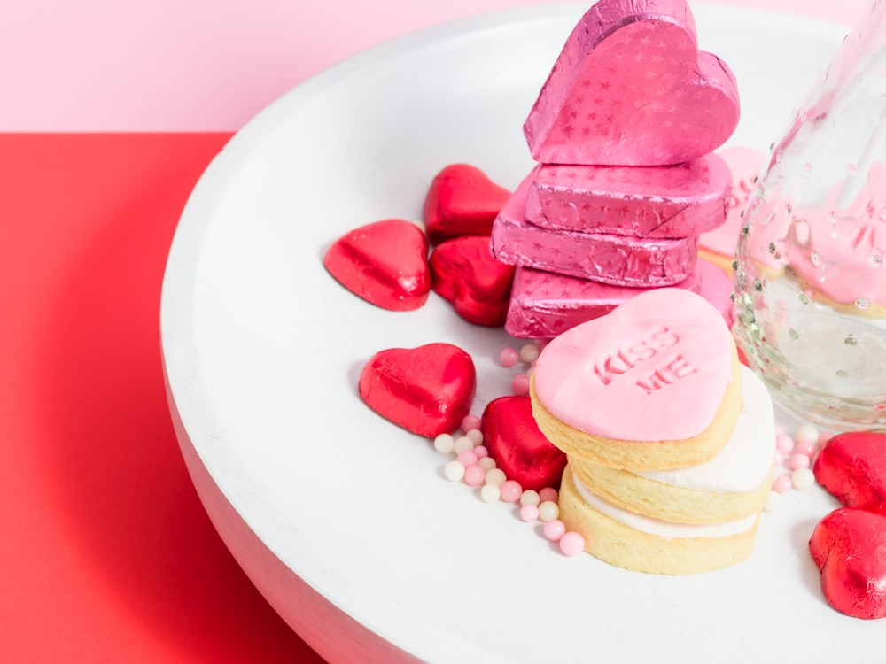 a white plate topped with lots of heart shaped cookies