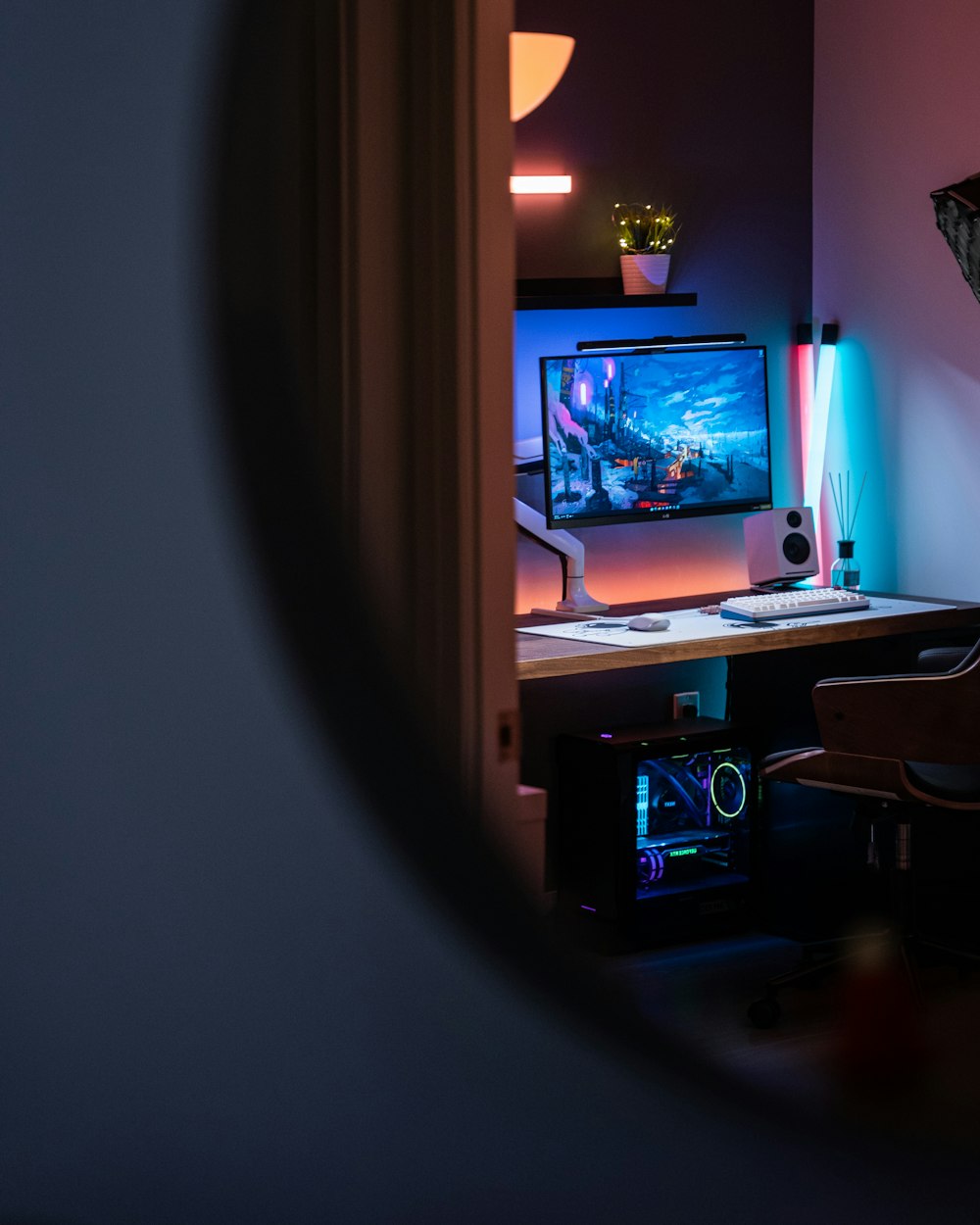 a computer desk with a monitor and keyboard