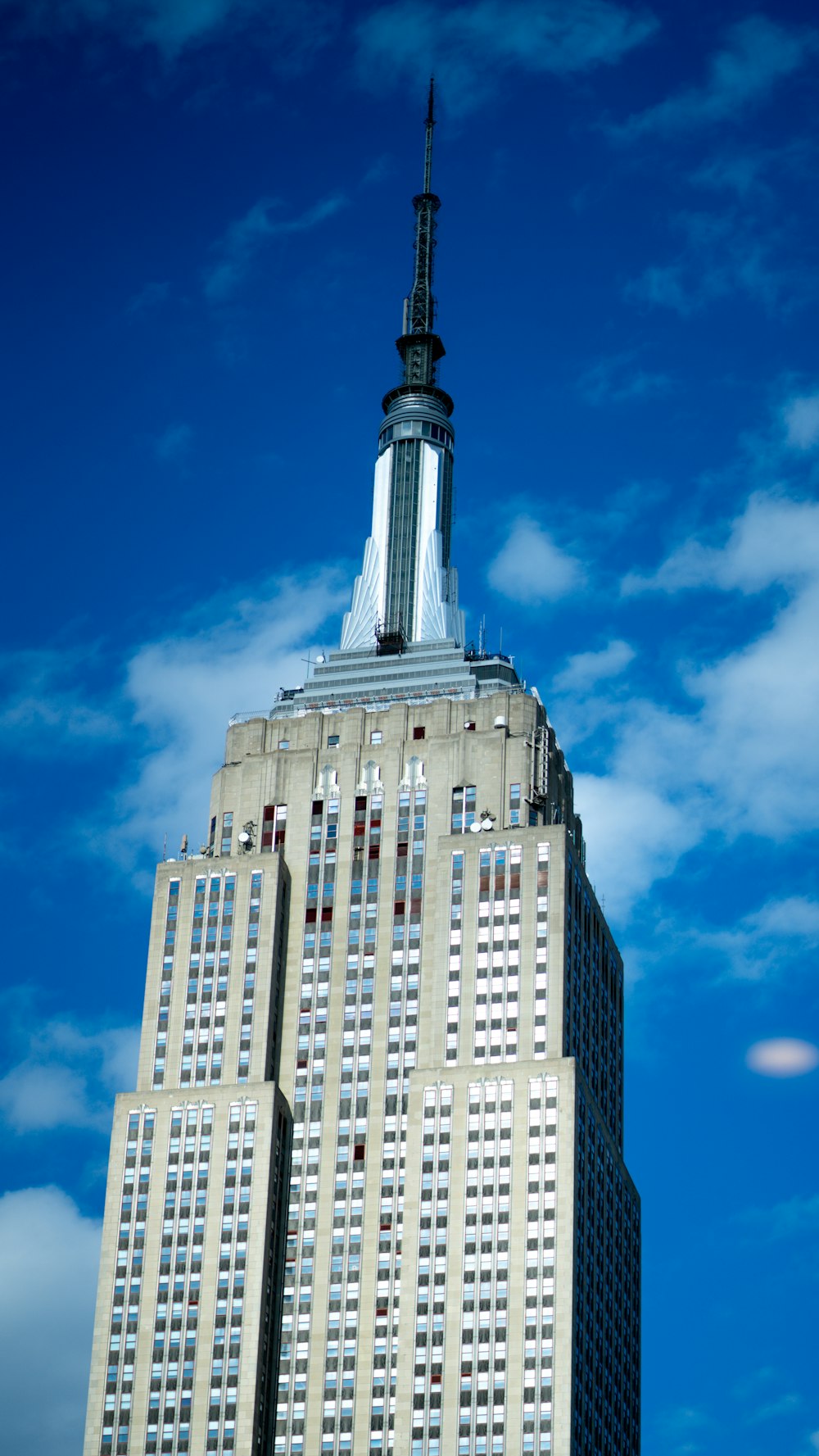 the top of a tall building with a sky background