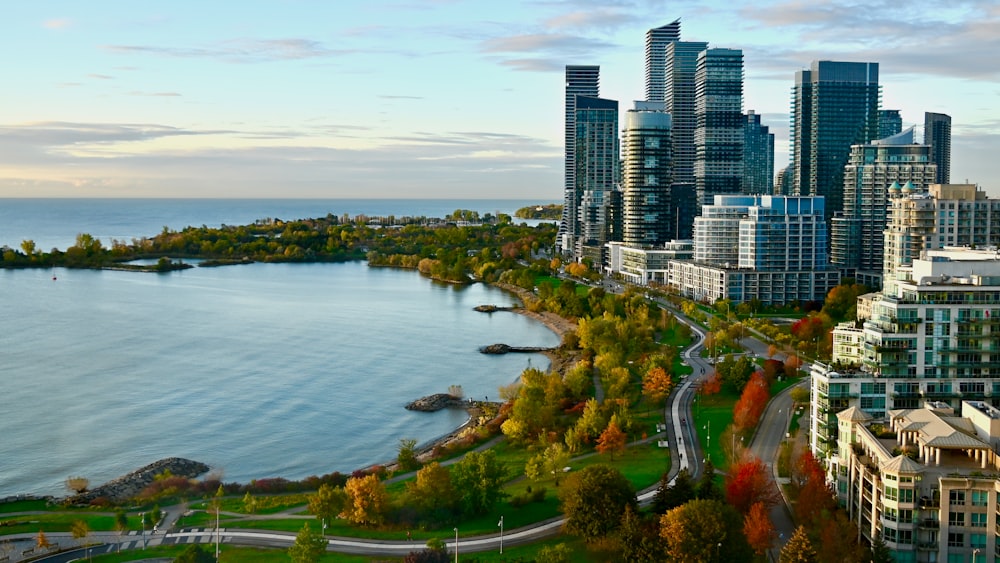 an aerial view of a city with a lake in the foreground