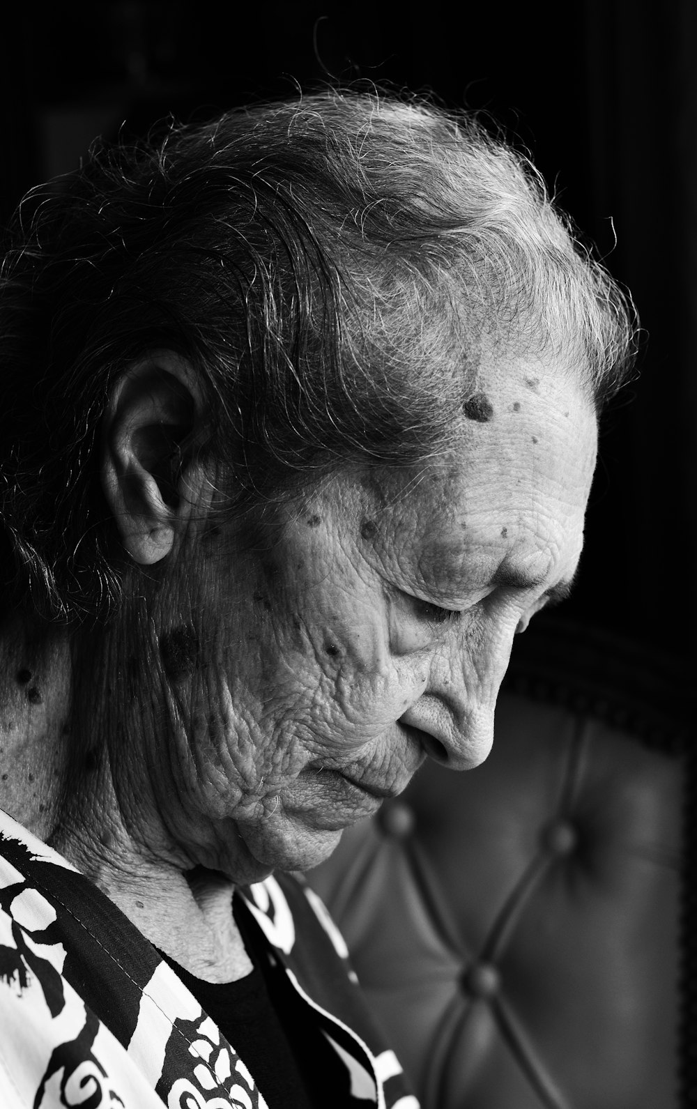 a black and white photo of an old woman