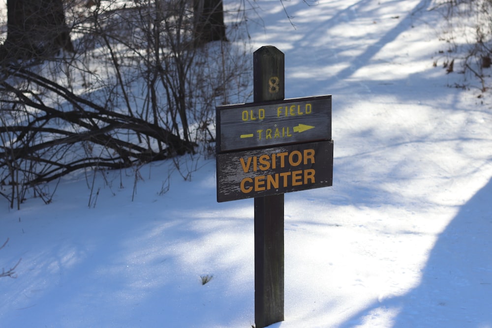 a sign on the side of a snow covered road