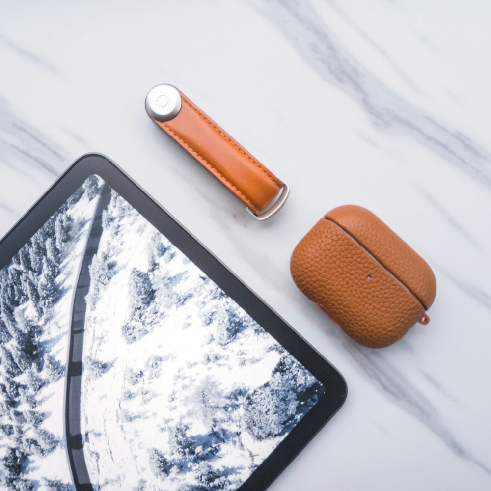 a tablet with a leather case next to it