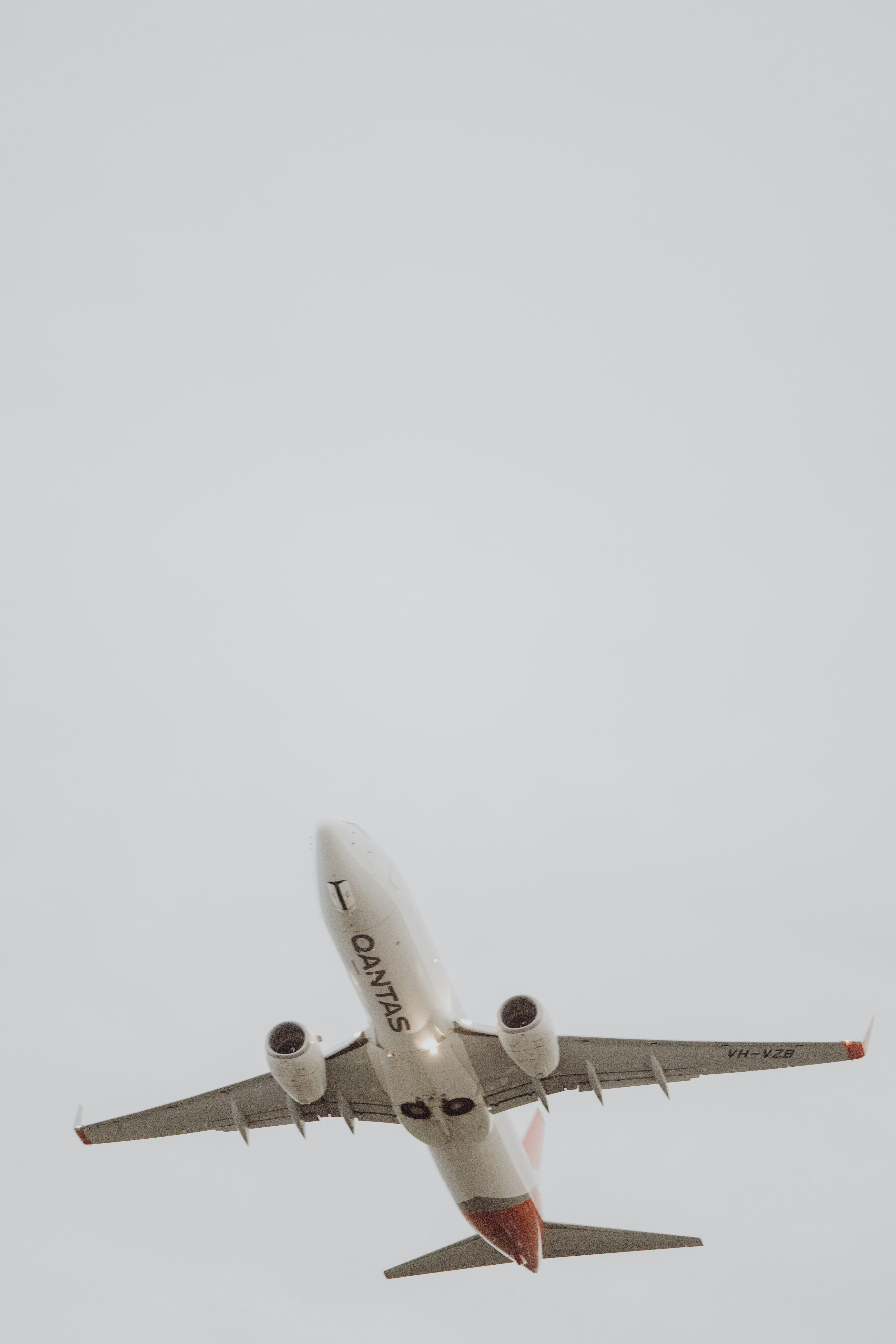 a large jetliner flying through a cloudy sky
