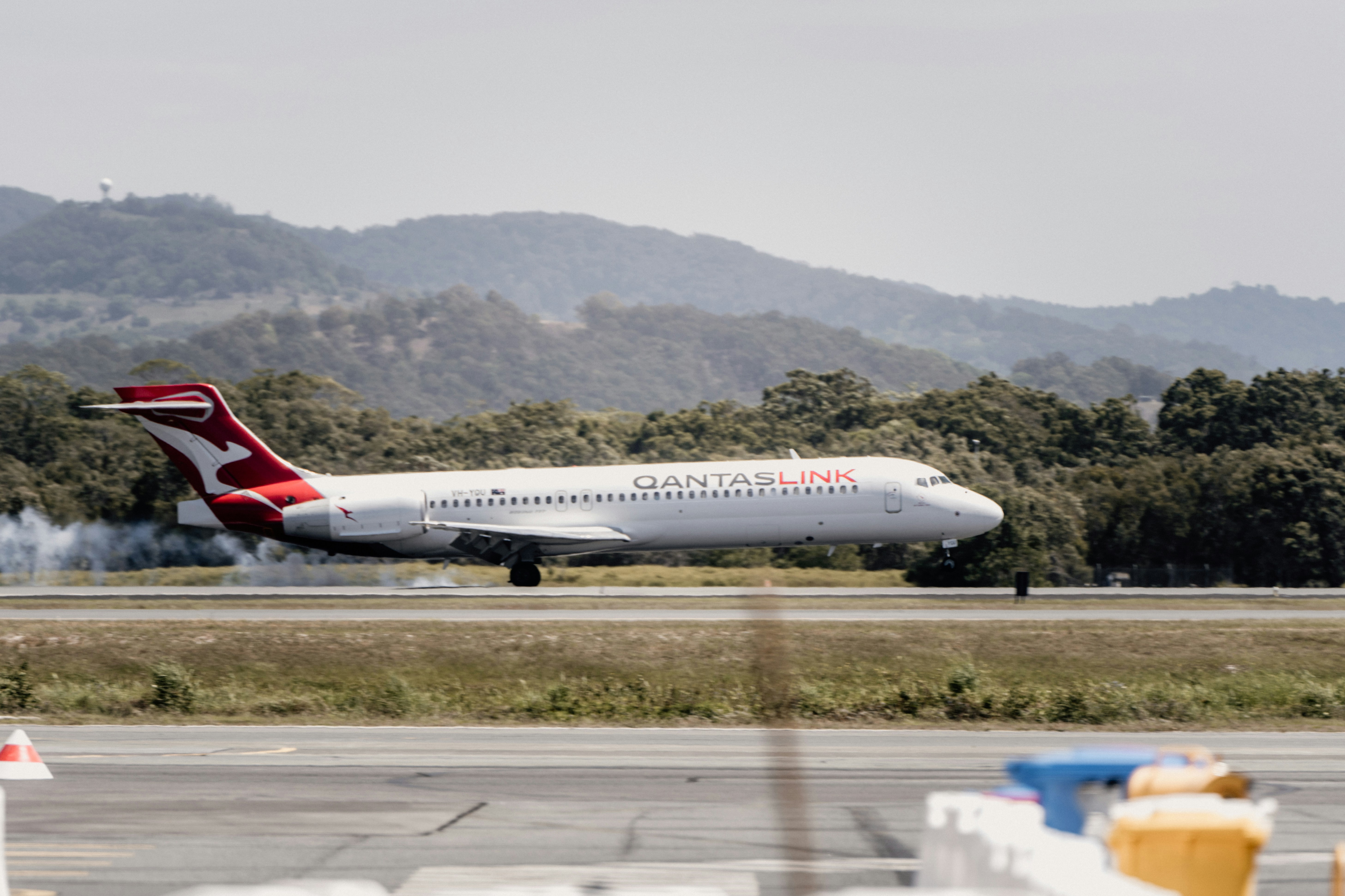 a large jetliner taking off from an airport runway, Gold Coast Airport by Josh Withers