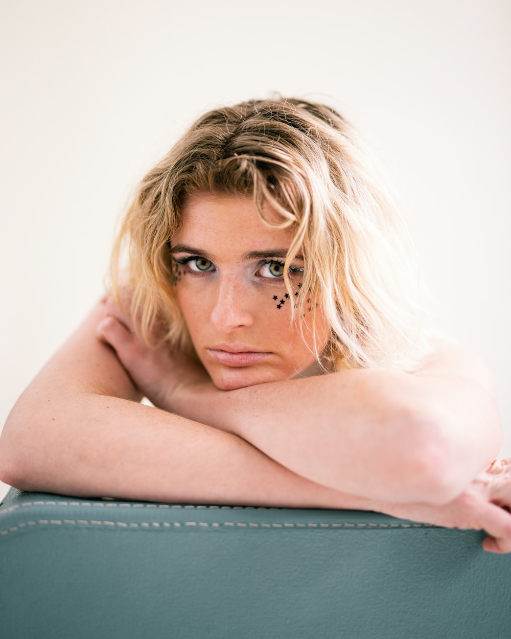 a woman sitting on top of a green chair