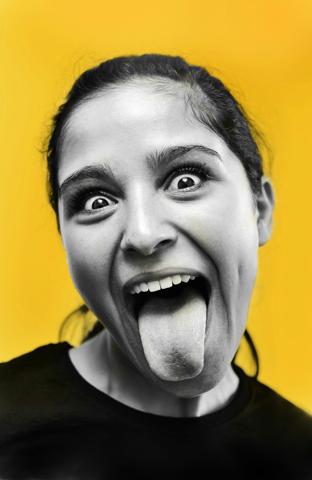 a woman making a funny face with her tongue out