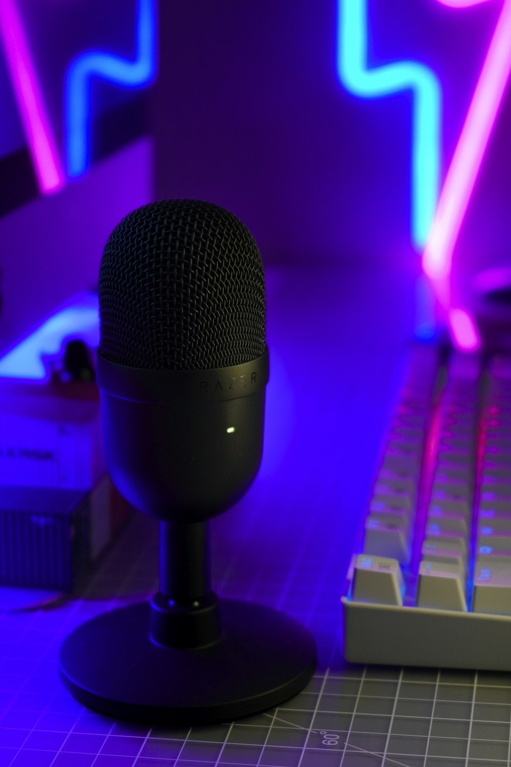 a microphone sitting next to a computer keyboard