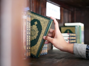 a person is holding a book in their hand