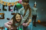 a young girl with a birthday hat on her head
