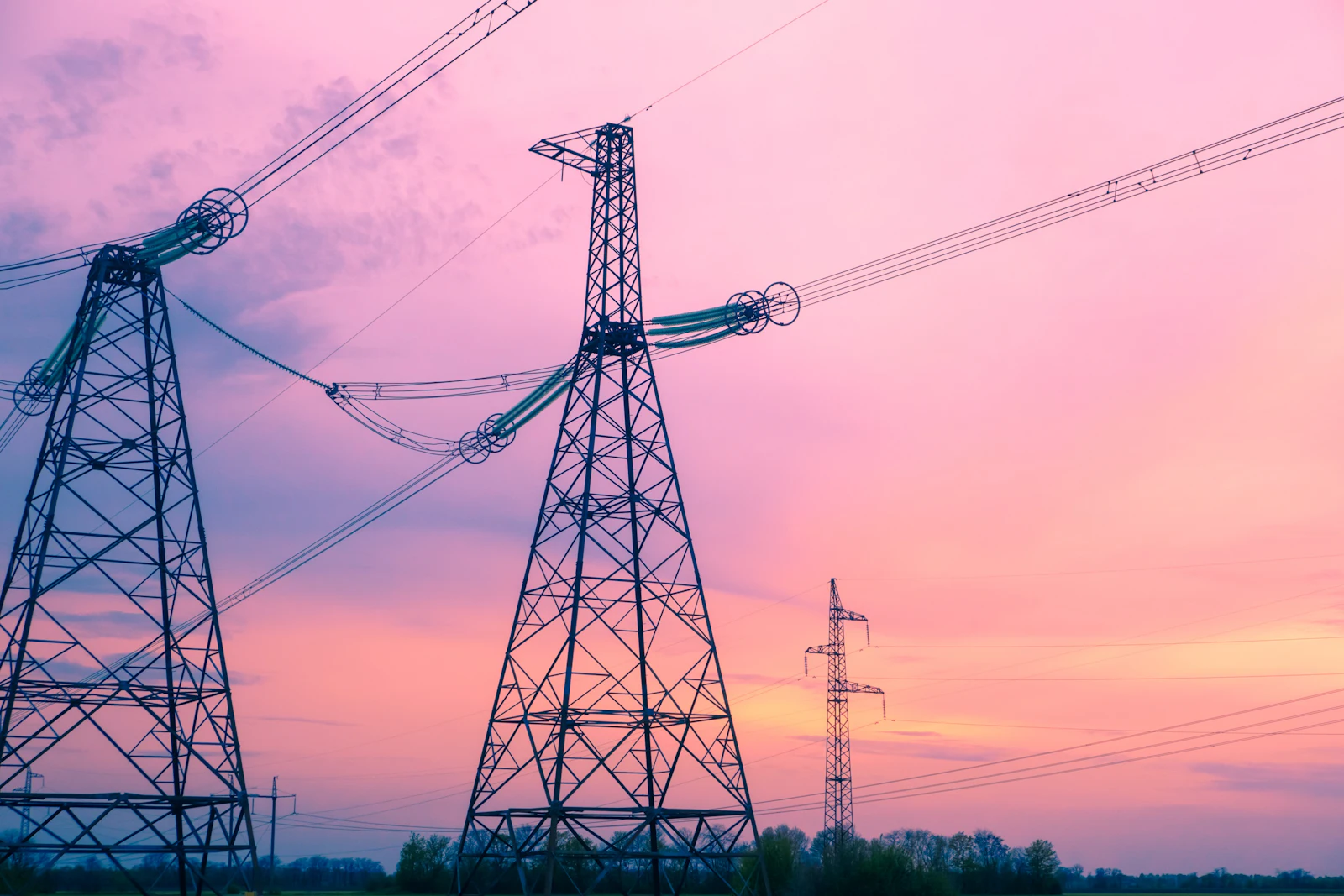 High-voltage transmission towers and lines at dusk