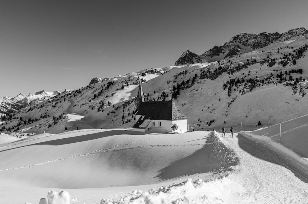 a black and white photo of a snowy mountain