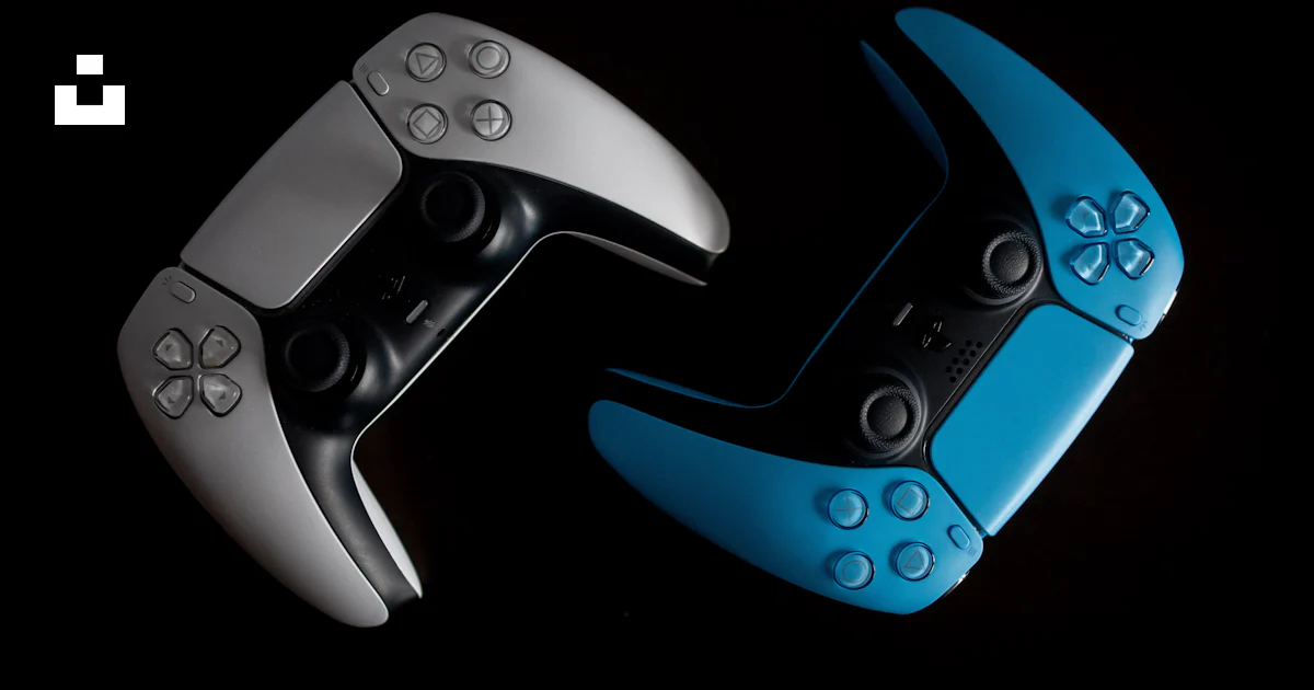 Two video game controllers sitting side by side photo – Free ...