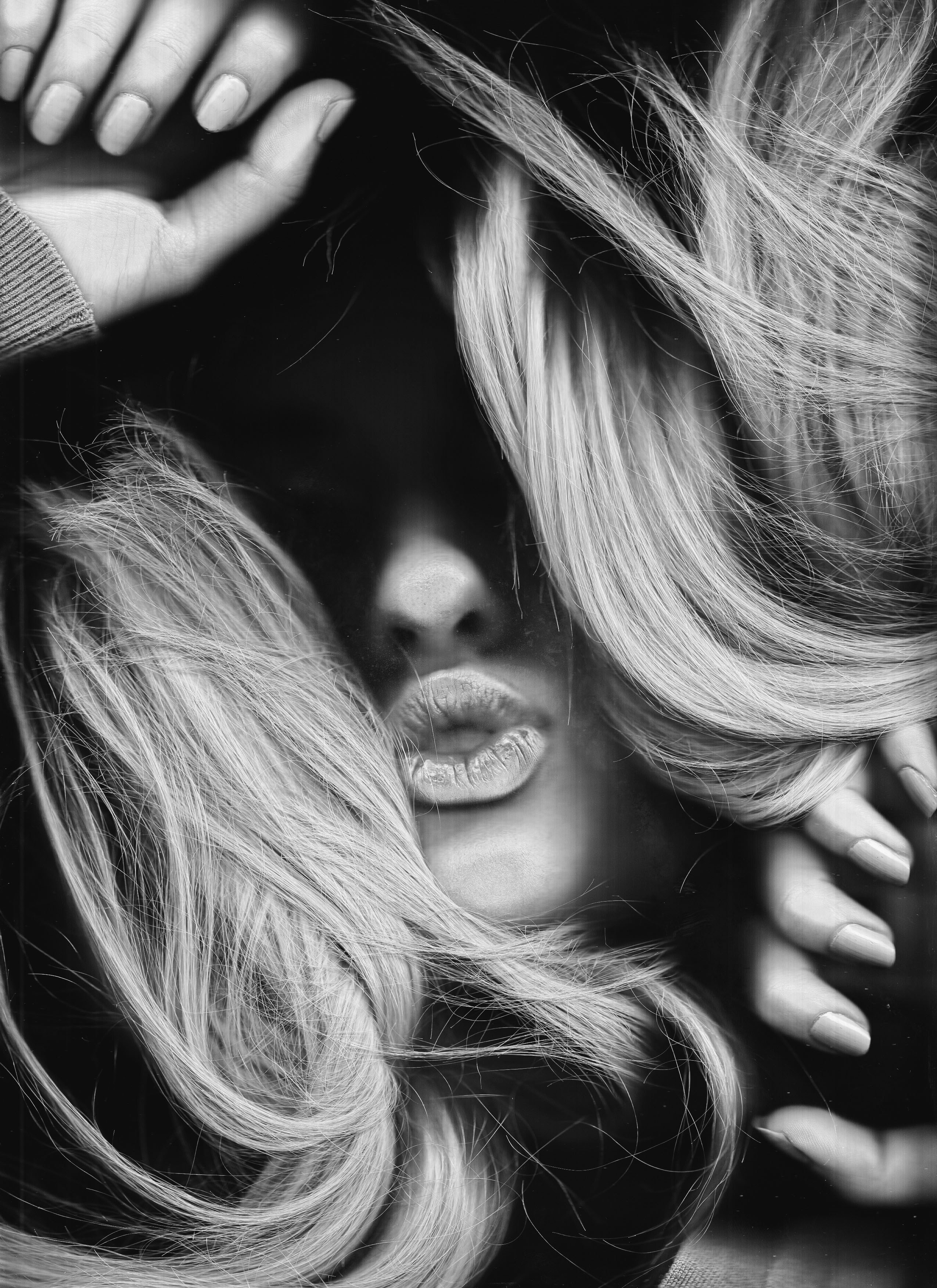 a black and white photo of a woman with blonde hair