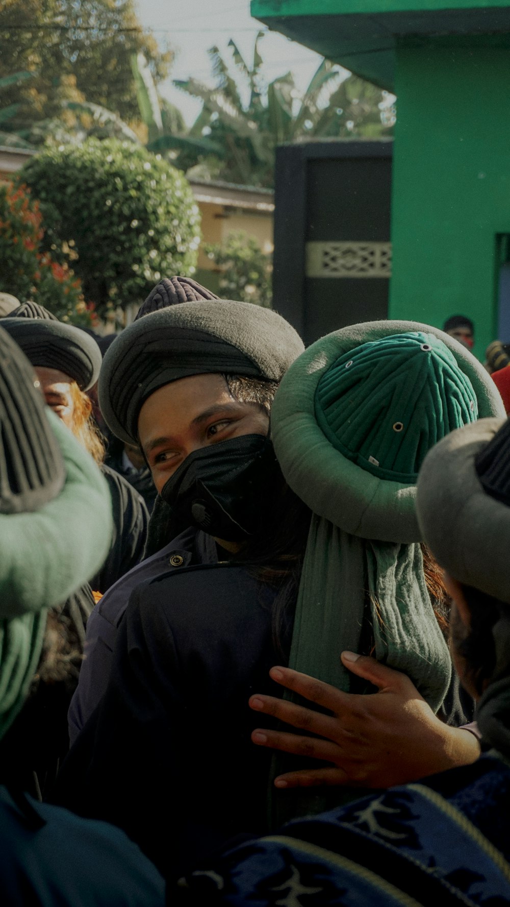 a group of people wearing hats and scarves