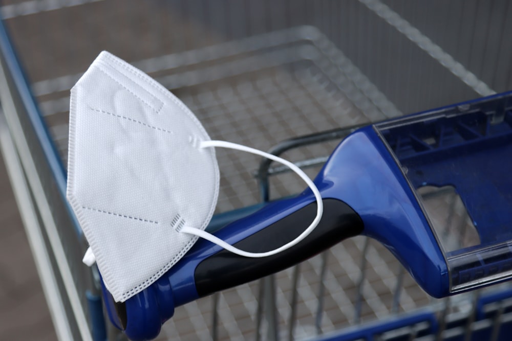 a face mask on top of a shopping cart