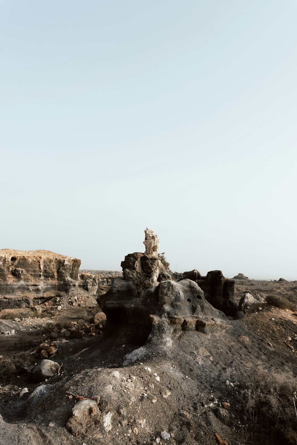 a barren landscape with rocks and dirt in the foreground