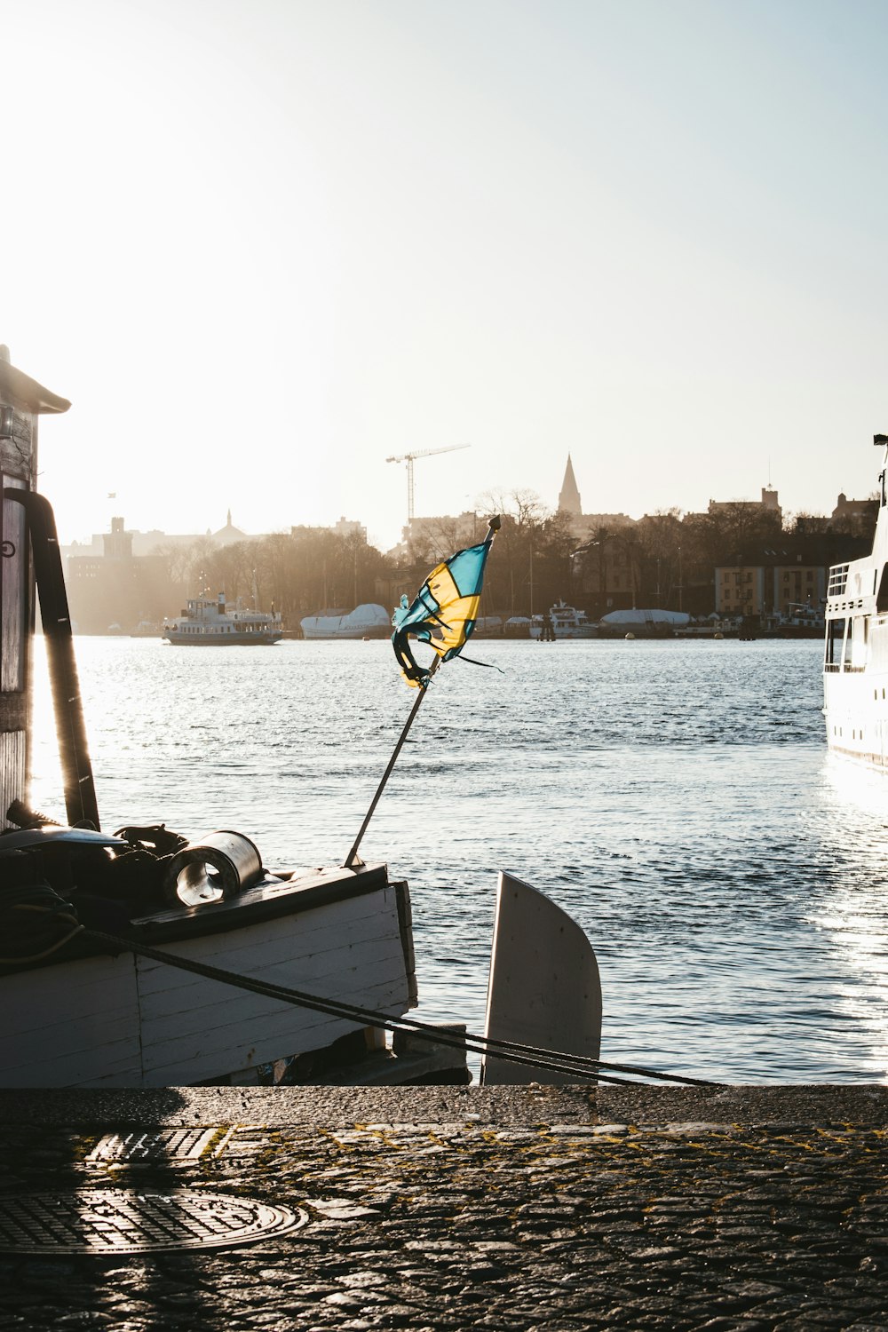 a small sailboat sitting on the shore of a lake