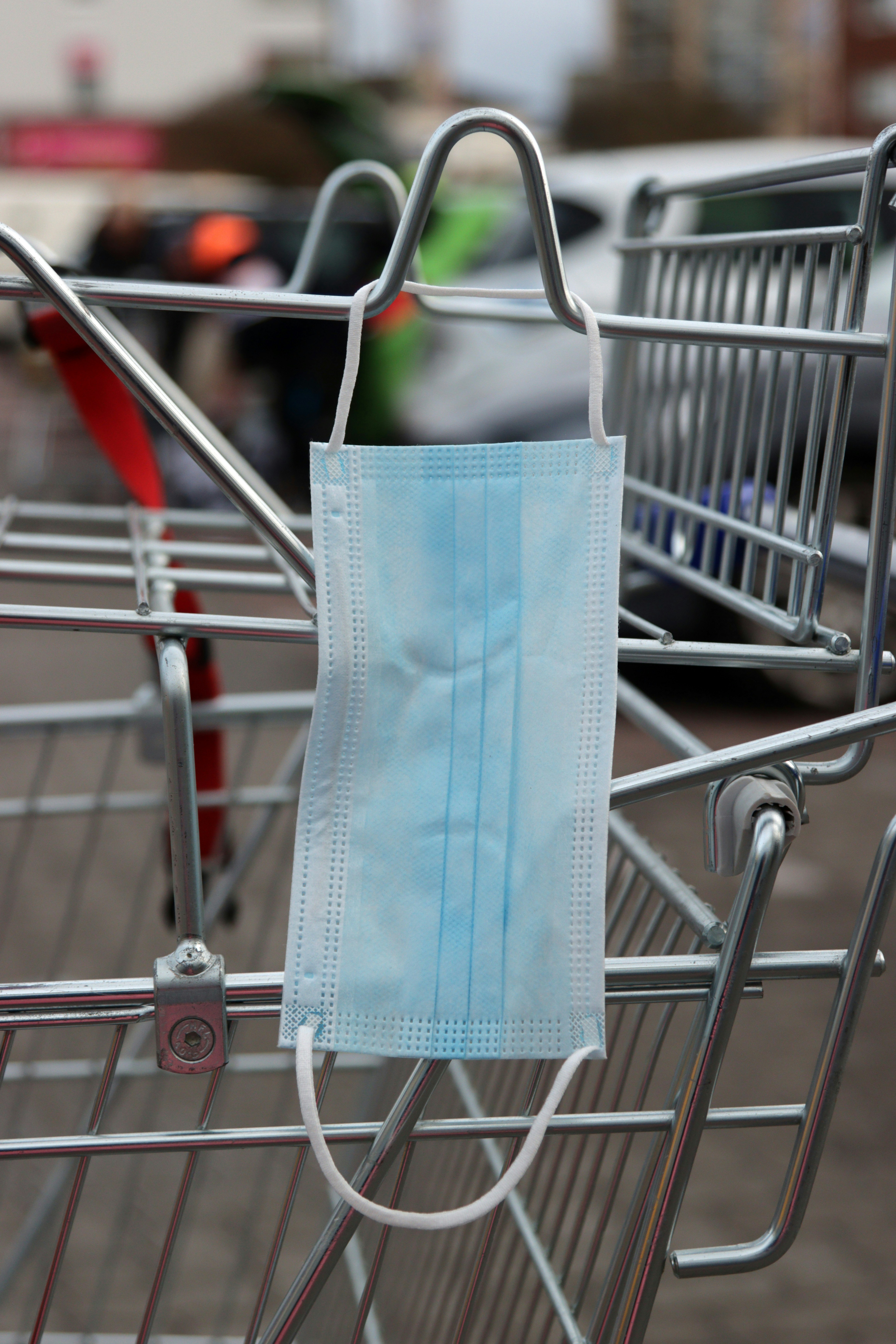 Person placing eco-friendly paper products in a shopping cart