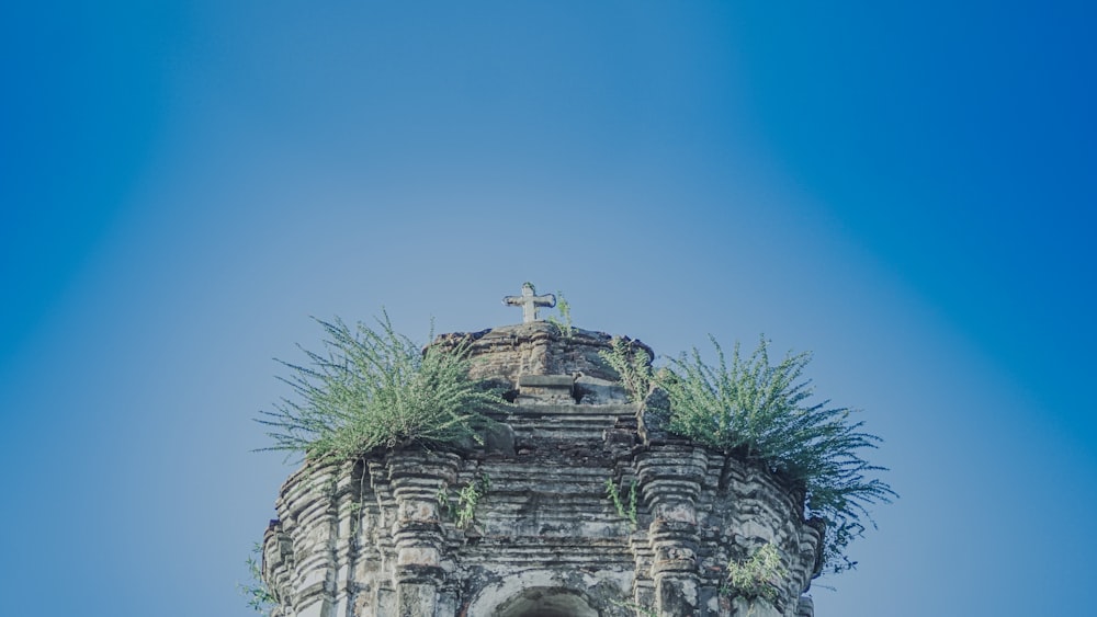 a tall tower with a cross on top of it