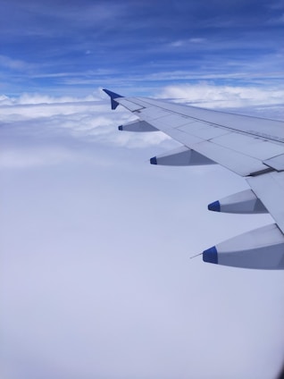 Modern aircraft soaring against a deep blue sky, symbolizing ambition and achievement.