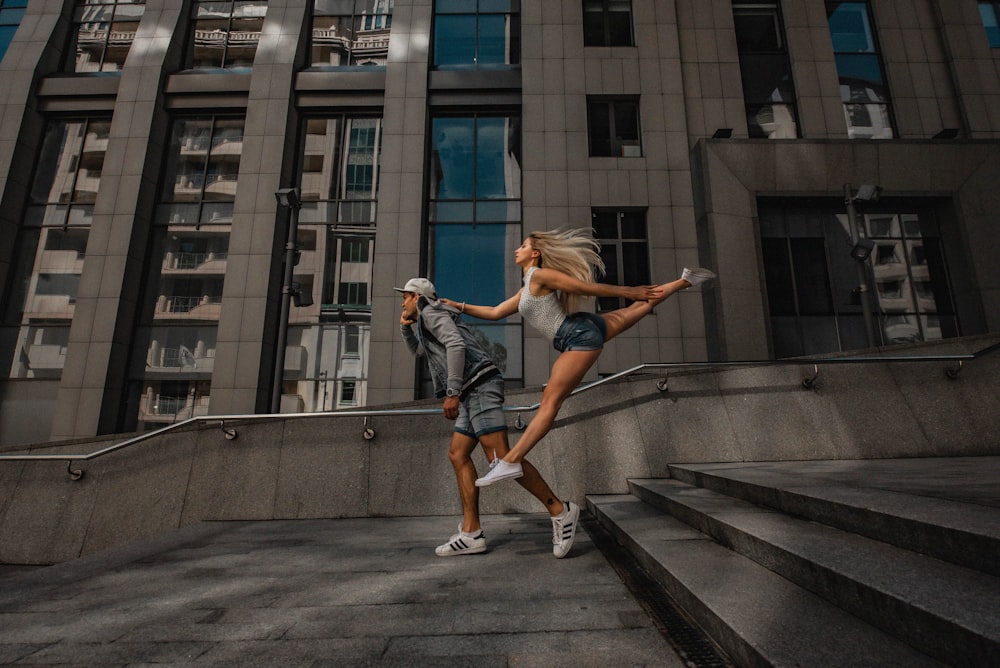 a man and a woman running down a flight of stairs