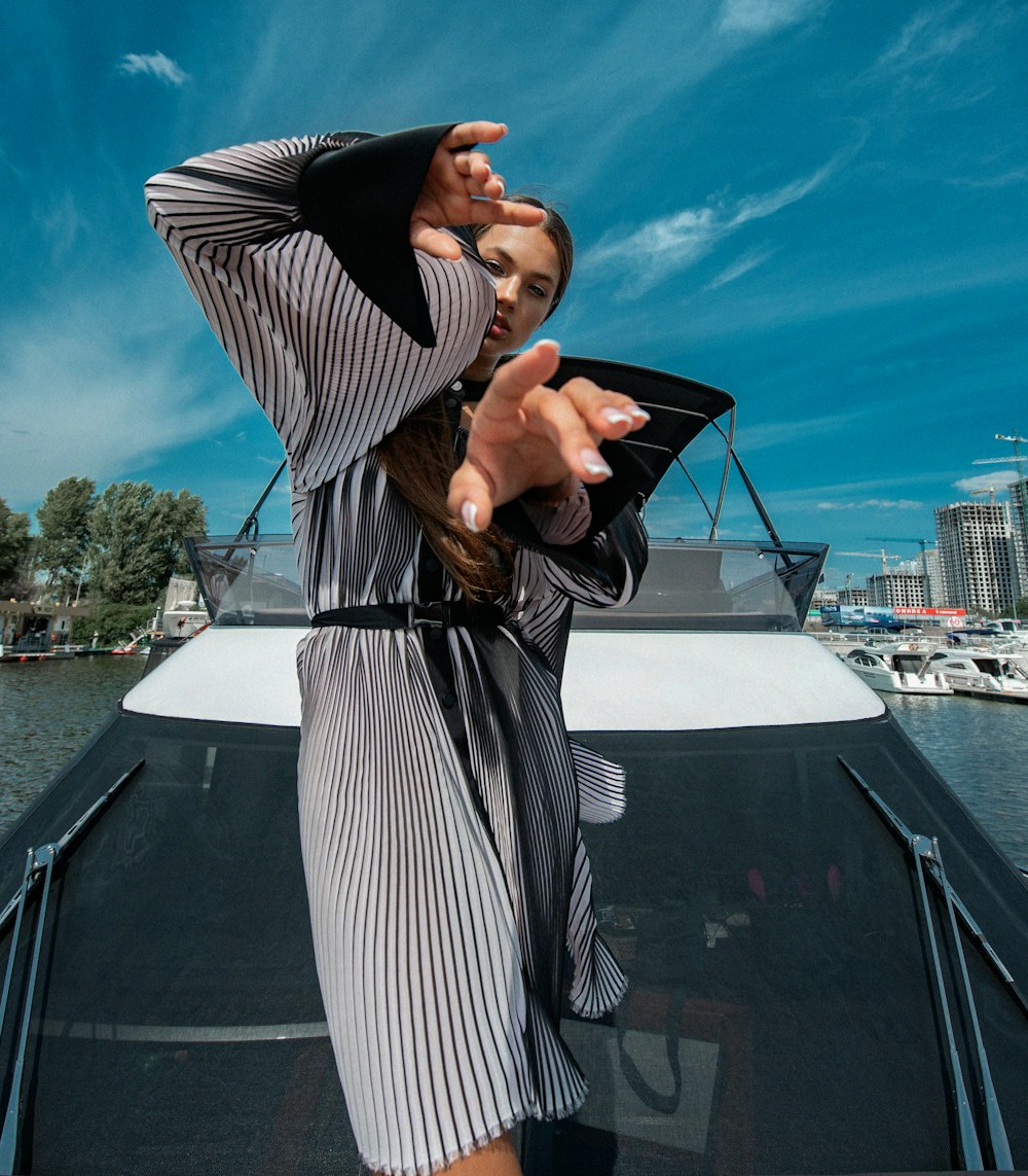 a woman in a striped dress on a boat